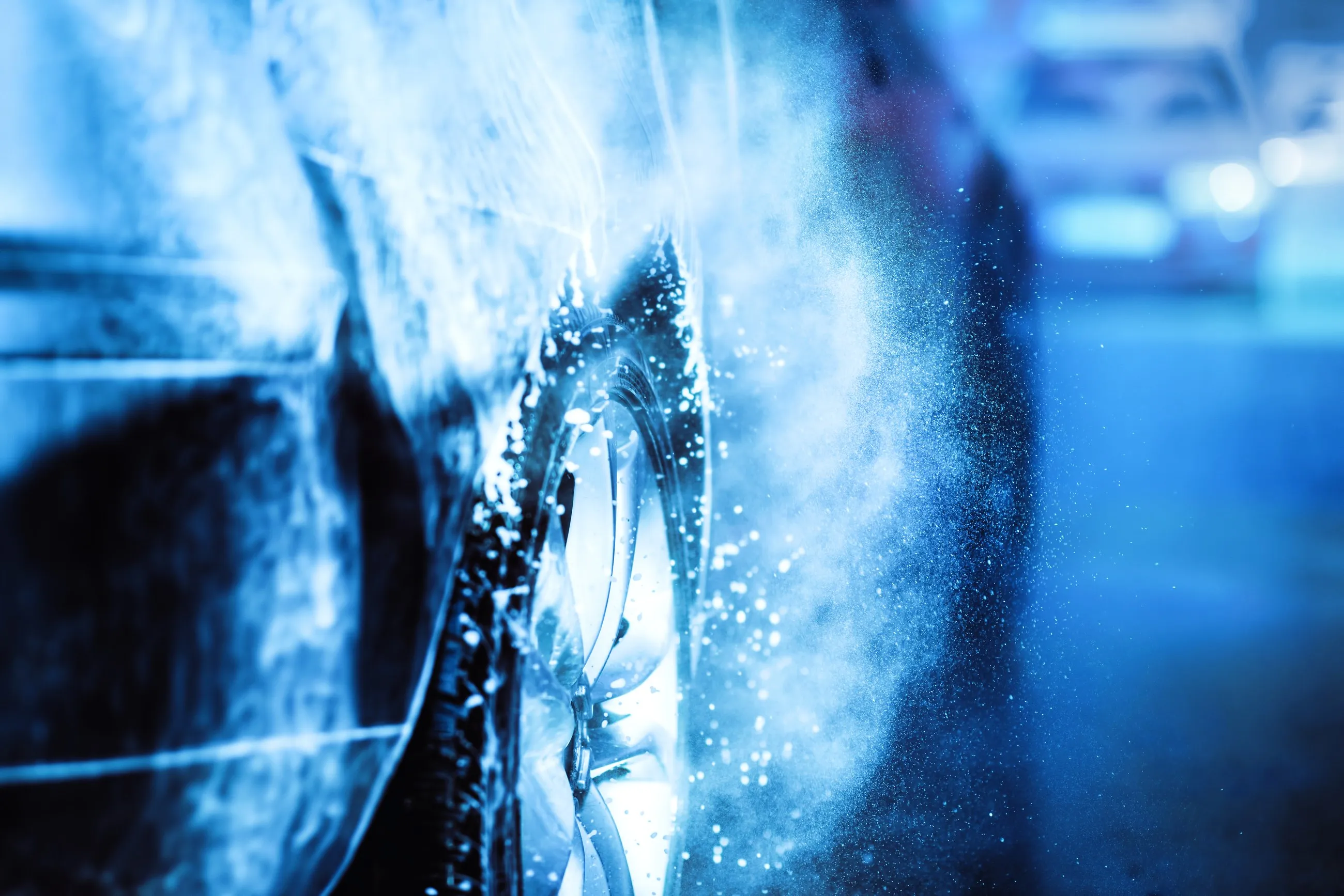 High-pressure jet cleaning the bonnet of a car